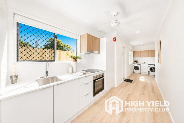 spacious common area with kitchen and laundry in a modern rooming house